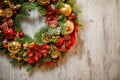 Christmas green artificial wreath with golden and red decoration toys in the left corner Royalty Free Stock Photo