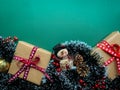 Christmas green background with snowman and Christmas presents. Top view composition with Christmas decorations, berries and p Royalty Free Stock Photo