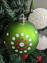 Christmas green ornament with white and red dots printed on it Royalty Free Stock Photo