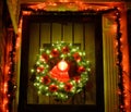 Christmas green wreath with red bells on the front door. Entrance to the house decorated for the winter holiday - Xmas and New Royalty Free Stock Photo