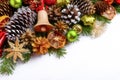 Christmas greeting background with jingle bell and spruce cones Royalty Free Stock Photo