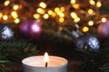 Christmas greeting caed with Christmas decorations, lights, Christmas tree branches, candle and bokeh. Close-up Royalty Free Stock Photo