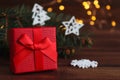 Christmas greeting caed with gift box, Christmas decorations, Christmas tree branches, and bokeh. Close-up, selective