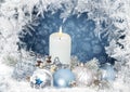 Christmas greeting card with candles, pine branches, balls on a blue background with a frosty pattern Royalty Free Stock Photo