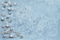 Christmas greeting card. Christmas silver decoration on blue background. Top view, copy space