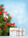 Christmas greeting card with decorater fir tree and gifts