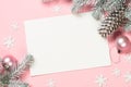 Christmas greeting card with empty blank sheet, fir tree and decorations on pink. Royalty Free Stock Photo