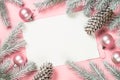 Christmas greeting card with empty blank sheet, fir tree and decorations on pink. Royalty Free Stock Photo