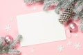 Christmas greeting card with empty blank sheet, fir tree and decorations on pink. Royalty Free Stock Photo