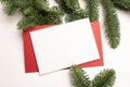 Christmas greeting card with envelope on wooden white background with fir tree branches and happy new year decorations Royalty Free Stock Photo