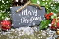 Christmas greeting card with german words for merry christmas - frohe weihnachten with christmas decorations on small slate chalk Royalty Free Stock Photo