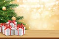 Christmas greeting card with gifts boxes on wooden table and tree bokeh background. Xmas and happy new year Royalty Free Stock Photo