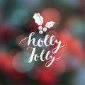 Christmas greeting card, invitation. Hand lettered text with holly icon. Festive modern blurred background with bokeh lights.