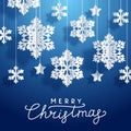 Christmas greeting card with paper snowflakes and stars on blue background for Your holiday design Royalty Free Stock Photo