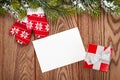 Christmas greeting card or photo frame and mittens over wooden t Royalty Free Stock Photo