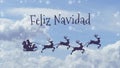 Christmas greeting with Santa Claus in a sleigh with the reindeer with the text Merry Christmas in Spanish Royalty Free Stock Photo