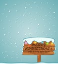 Christmas greeting was written on a snowy wooden board Royalty Free Stock Photo