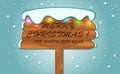 Christmas greeting was written on a snowy wooden board Royalty Free Stock Photo