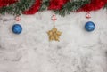 Christmas grey background with big blue baubles and gold star. Red and green tinsel top. Space for text Royalty Free Stock Photo