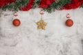 Christmas grey background with big red baubles and gold star. Red and green tinsel top. Space for text Royalty Free Stock Photo