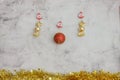 Christmas grey background with golden candy and big red baubles. golden tinsel bottom. Space for text Royalty Free Stock Photo