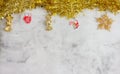 Christmas grey background with golden candy, mitten and snow stars. golden tinsel top. Space for text Royalty Free Stock Photo