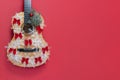 Christmas guitar on a red background with snowflakes and red bows. An invitation to a New Year's musical concert. Winter Royalty Free Stock Photo