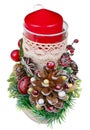 Christmas handmade candlestick with a big red candle in rustic style made pine cones red berries and birch stump isolated