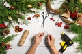 Christmas handmade diy background. Making craft xmas wreath and ornaments. Top view of white wooden table with female Royalty Free Stock Photo