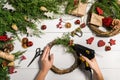 Christmas handmade diy background. Making craft xmas wreath and ornaments. Top view of white wooden table with female Royalty Free Stock Photo