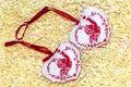 Christmas handmade embroidered decorations soft toys on the straw tinsel  background top view shape of hear, bell, angel, fir tree Royalty Free Stock Photo