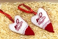Christmas handmade embroidered decorations soft toys on the straw tinsel background top view shape of hear, horse