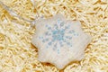 Christmas handmade embroidered decorations soft toys on the straw tinsel background top view shape of snowflake