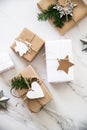 Christmas handmade gift boxes on white marble background top view. Merry Christmas greeting card, frame. Winter xmas holiday theme Royalty Free Stock Photo