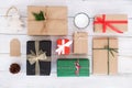 Christmas handmade present gift boxes and rustic decoration on white wooden board. Royalty Free Stock Photo