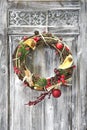 Christmas handmade wreath on wooden door.