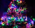 Christmas hanging decorations on fir tree. Decorated Christmas tree. Fir branch with Christmas decorations surrounded by lights Royalty Free Stock Photo