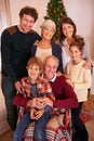 Christmas, happy and big family portrait in home with young children, parents and grandparents. Happiness, love and Royalty Free Stock Photo