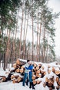 Christmas happy couple in love embrace in snowy winter cold forest, copy space, new year party celebration, holiday and