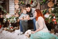 Christmas happy family of three persons and fir tree with gift boxes new year winter decorated background Royalty Free Stock Photo
