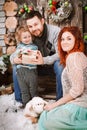 Christmas happy family of three persons and fir tree with gift boxes new year winter decorated background Royalty Free Stock Photo