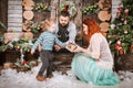 Christmas happy family of three persons and fir tree with gift boxes new year winter decorated background Royalty Free Stock Photo