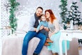 Christmas happy family of three persons and fir tree with gift boxes over white bedroom background Royalty Free Stock Photo