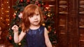 Christmas happy girl. Luxury attractive red hair child. Xmas miracle.