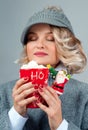 Christmas and New Year. Woman in knitted hat is drinking coffee. Royalty Free Stock Photo