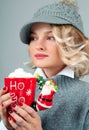 Christmas and New Year. Woman in knitted hat is drinking coffee. Royalty Free Stock Photo