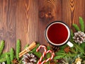 Christmas and Happy New Year background with tea. Top view, copy space. Fir branches, brown dark wooden table Royalty Free Stock Photo