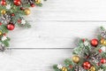 Christmas or Happy New Year composition made of fir tree branches, holiday decorations on white wooden background Royalty Free Stock Photo