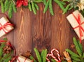 Christmas and Happy New Year dark brown background. Gift Christmas box, fir branches, wooden table, top view, copy space Royalty Free Stock Photo