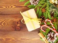 Christmas and Happy New Year dark brown background. Gift Christmas box, fir branches, wooden table, top view, copy space Royalty Free Stock Photo